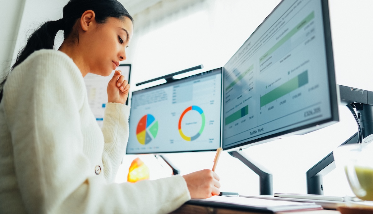 Woman with back pain working at standing desk home office