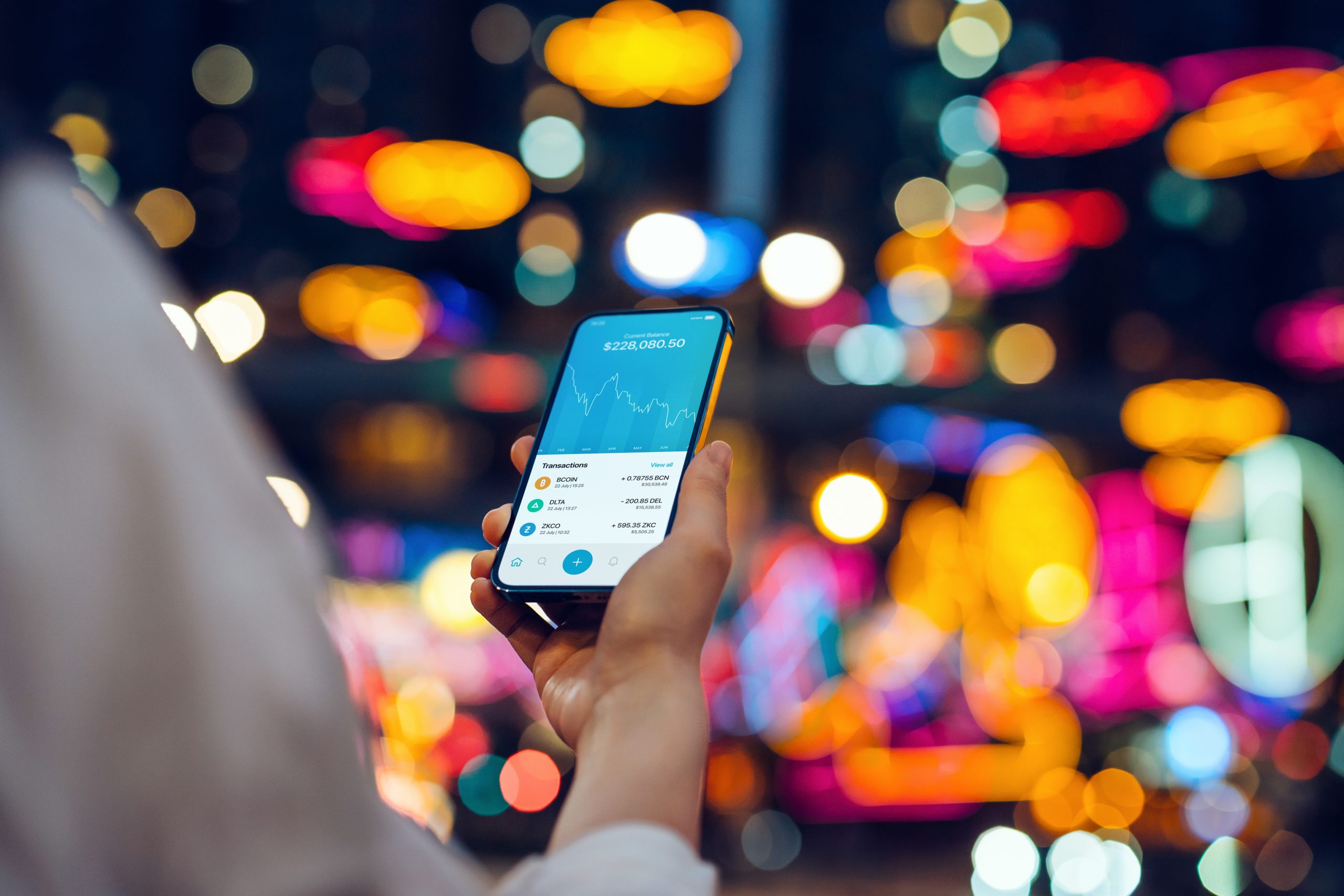 Young woman using NFT investment wallet on smartphone